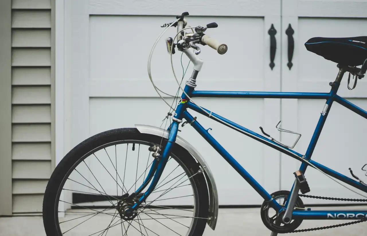 Blue bicycle in front of a white wall